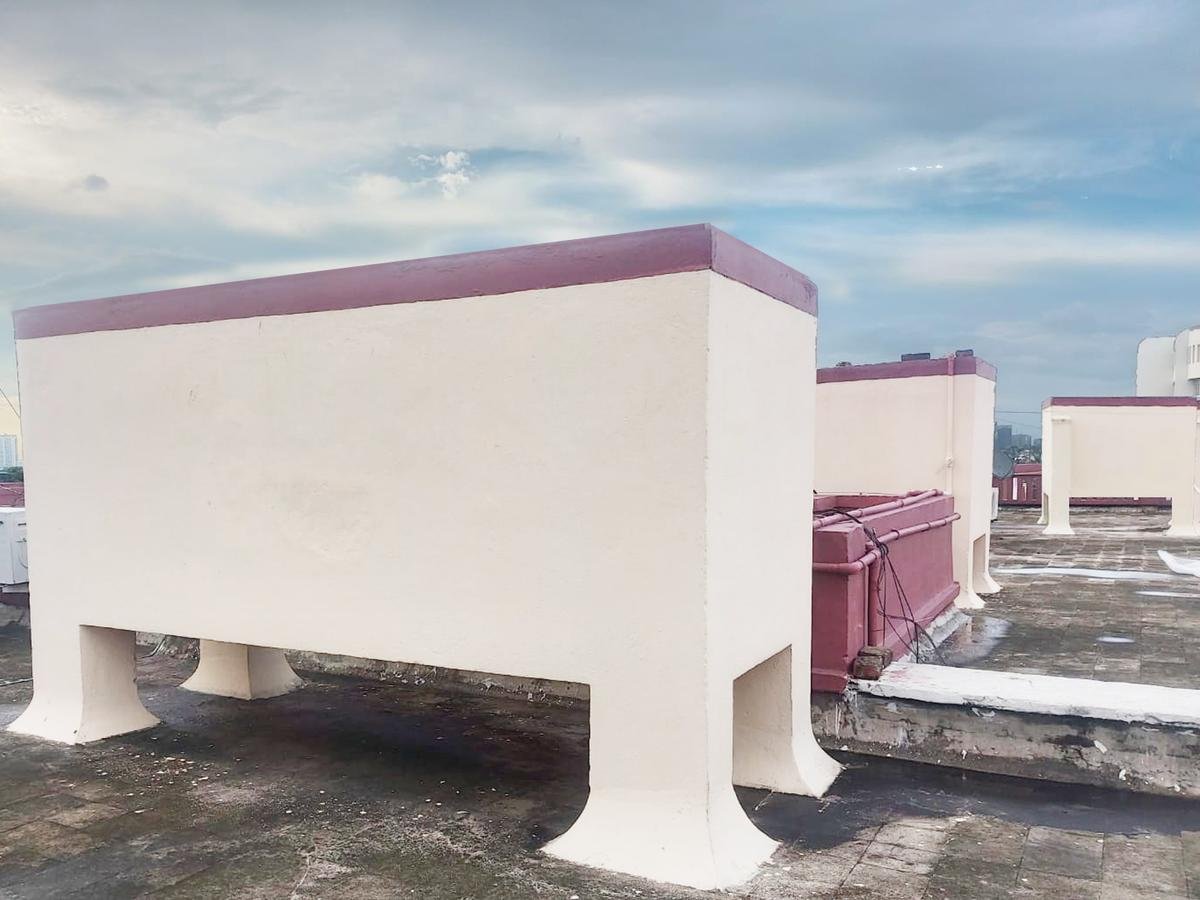Overhead water tanks on an apartment rooftop in Kolkata