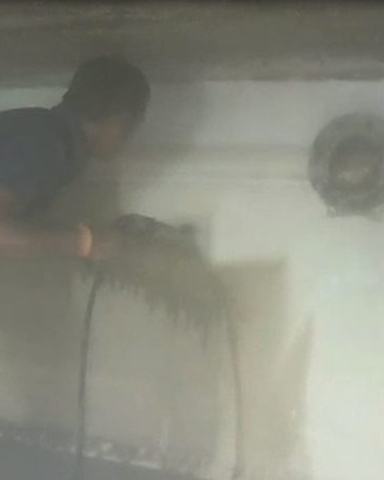 Anti-bacterial wall treatment being applied inside the tank in Kalighat, Kolkata